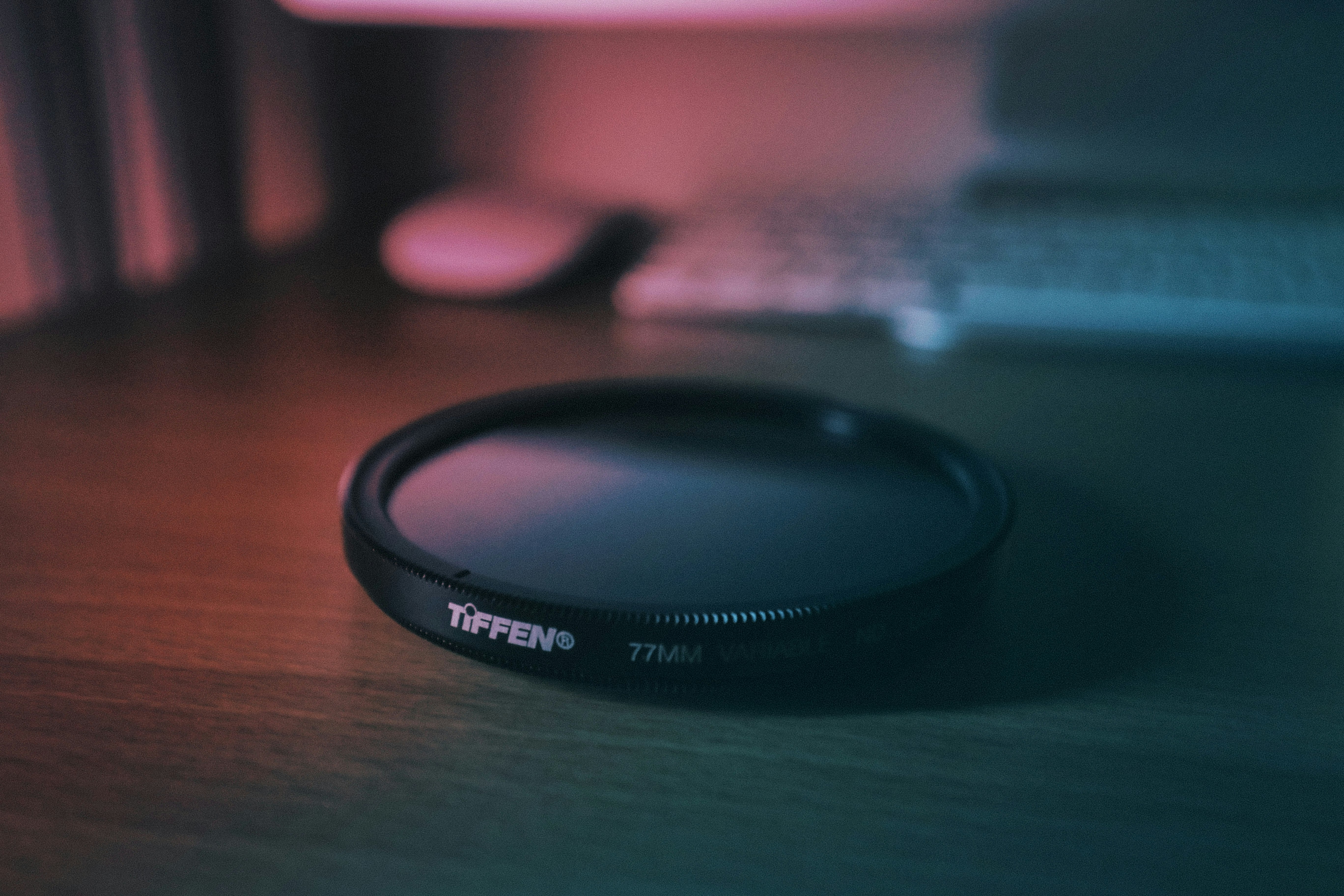 round black Tiffen cover near white computer keyboard